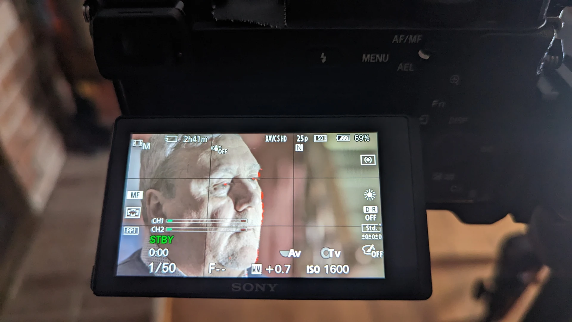 Setting up — the camera’s viewfinder, with Jim Geddis’s face in it.