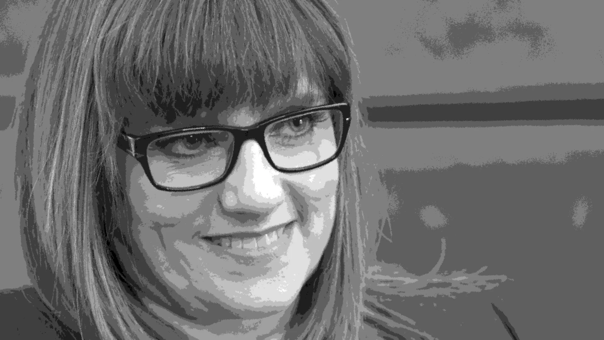 The cut. A frame pulled from the working edit — a face, glasses, the finished grade.