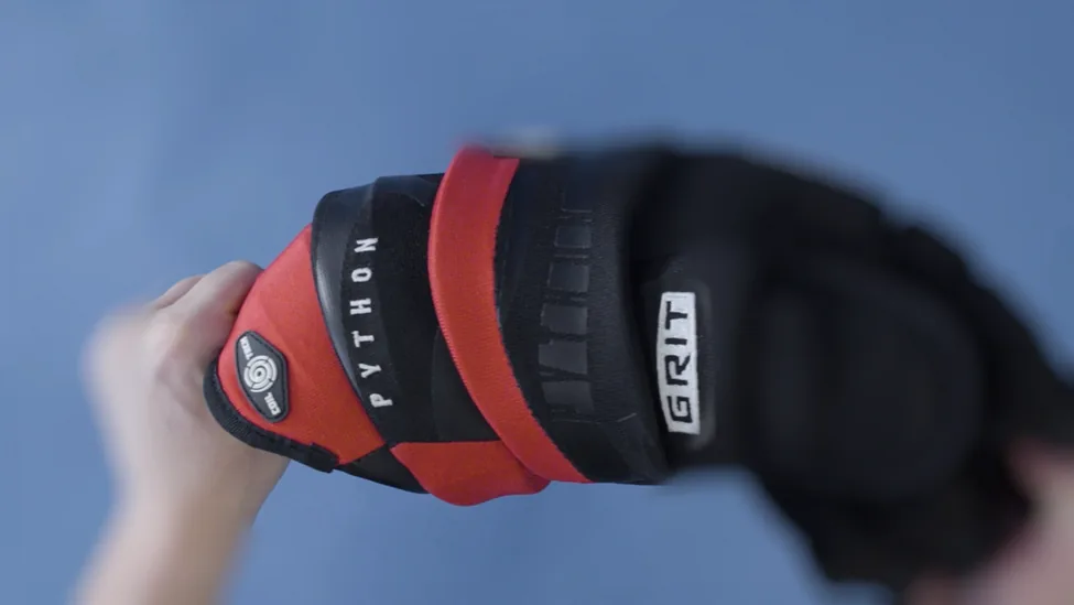 The new GRIT Python Coil Tech hockey glove in front of a blue screen
