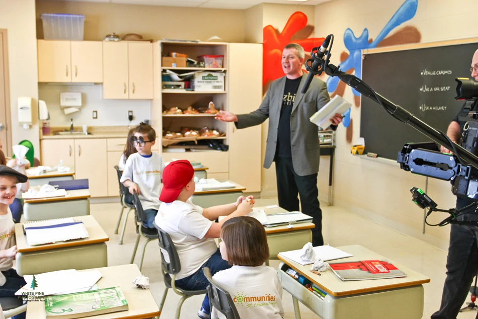 The teacher and the class. Bob at the front with the children, microphone in hand.