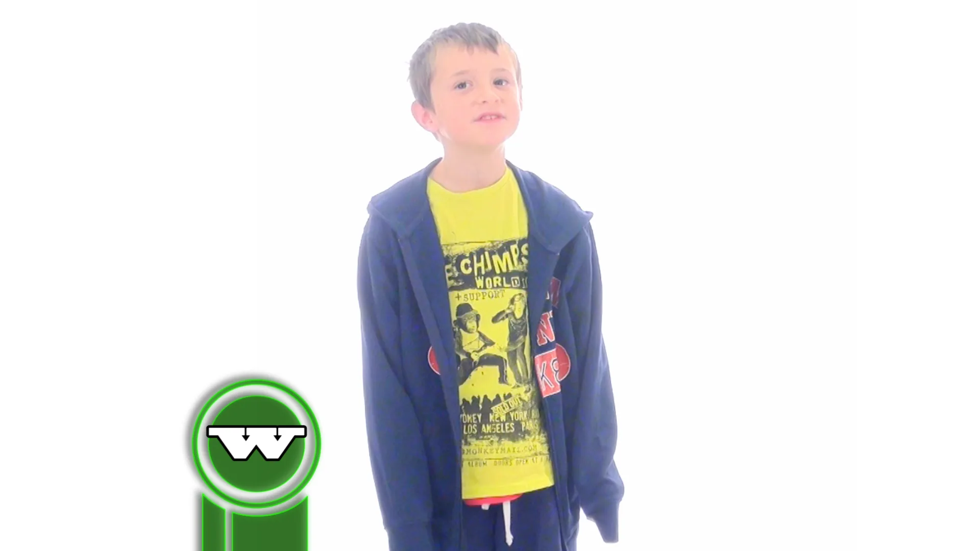 A young person in a navy hoodie layered over a yellow graphic T-shirt stands against a plain white backdrop.